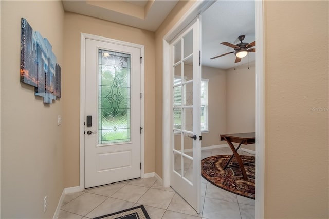 doorway with light tile patterned flooring, french doors, and ceiling fan