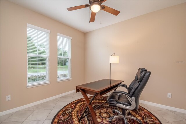 office with light tile patterned floors and ceiling fan