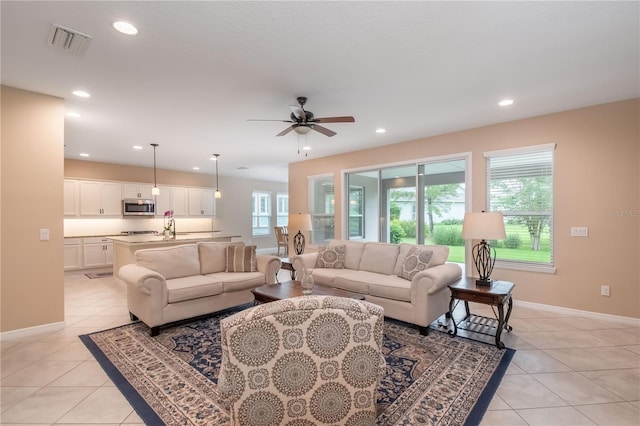 tiled living room featuring ceiling fan