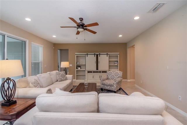 living room with ceiling fan and light tile patterned floors