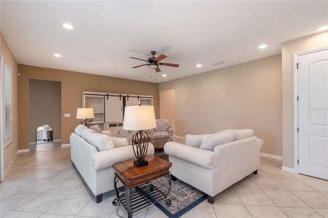 tiled living room with ceiling fan