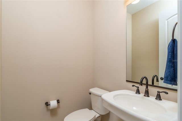 bathroom featuring sink and toilet