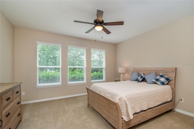 bedroom featuring light carpet and ceiling fan