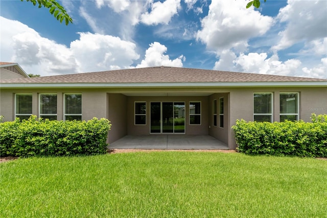 back of property with a patio and a yard