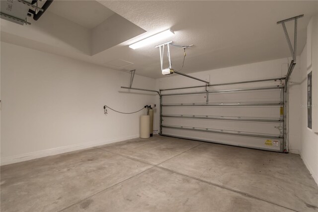 garage featuring a garage door opener and water heater