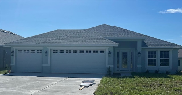 view of front of property featuring a front lawn and a garage