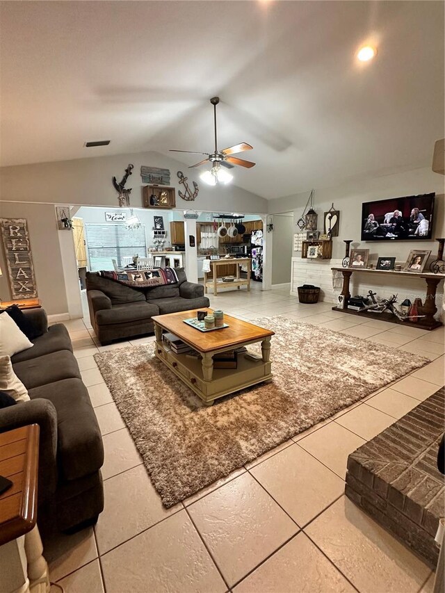 tiled living room with lofted ceiling and ceiling fan