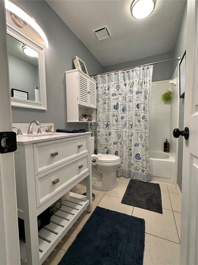 full bathroom featuring tile patterned flooring, shower / bath combo, toilet, and vanity