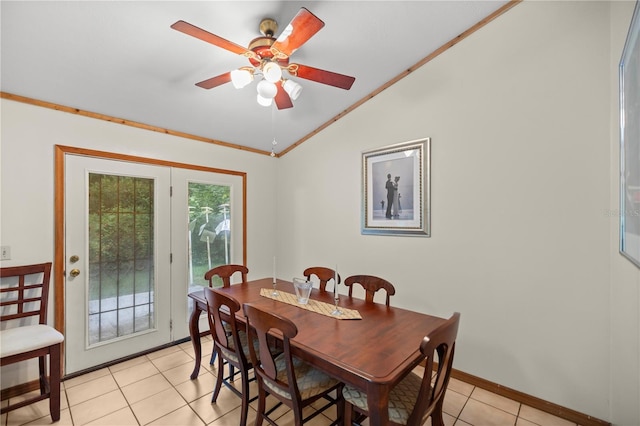 tiled dining space featuring crown molding, ceiling fan, and lofted ceiling