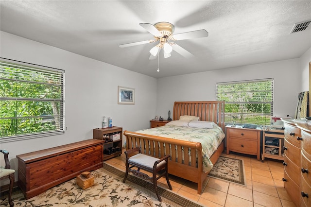 bedroom featuring light tile patterned flooring and ceiling fan