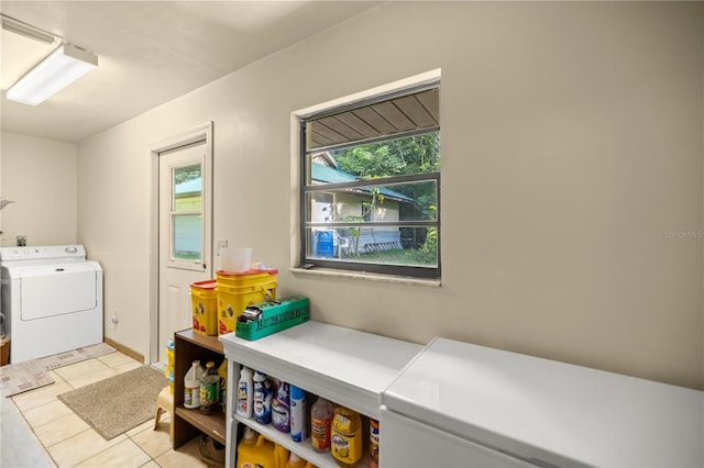 laundry room featuring washer / dryer and light tile patterned floors