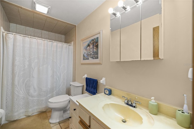 bathroom featuring vanity, tile patterned flooring, and toilet