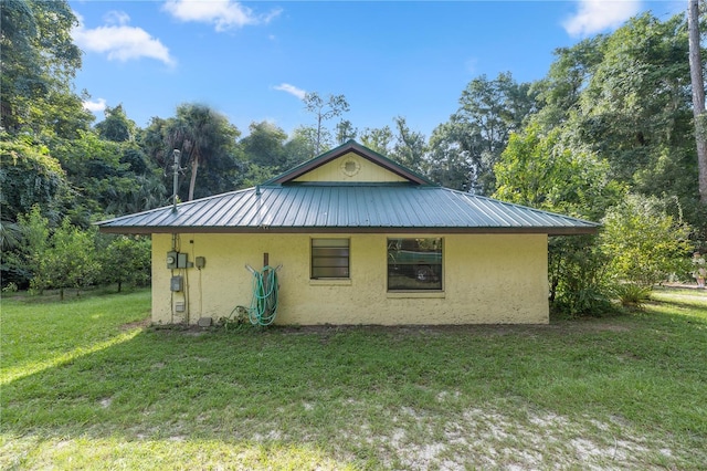 view of side of property with a lawn