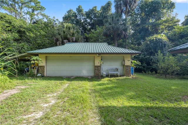 garage featuring a lawn