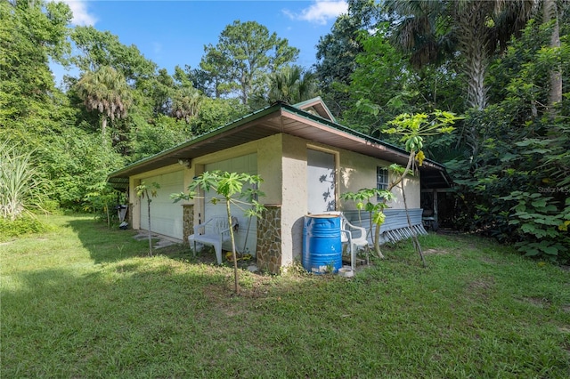 view of side of property with a garage and a yard