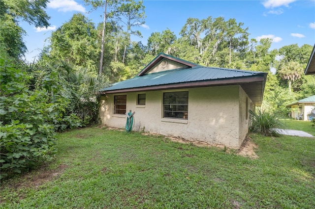 view of side of home featuring a yard