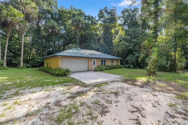 view of front of property featuring a garage and a front yard