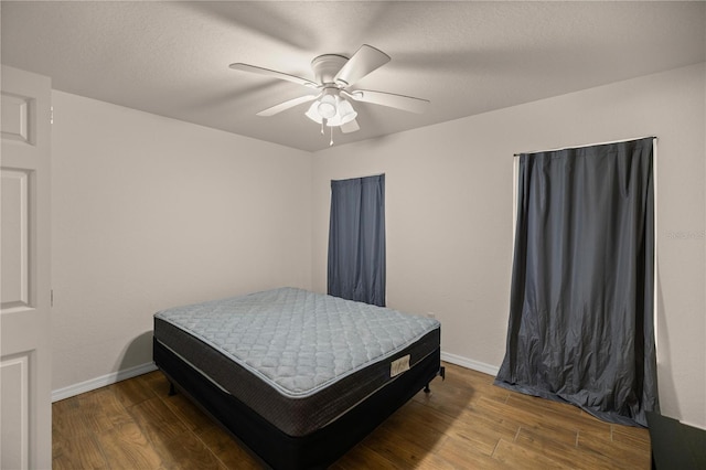 bedroom with hardwood / wood-style floors and ceiling fan