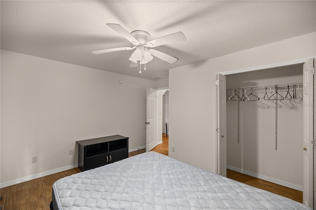 bedroom with ceiling fan, hardwood / wood-style flooring, and a closet