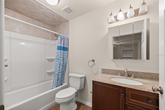 full bathroom with hardwood / wood-style floors, vanity, shower / bath combo with shower curtain, and toilet