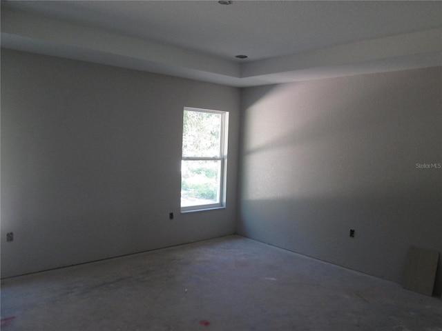 unfurnished room with concrete flooring