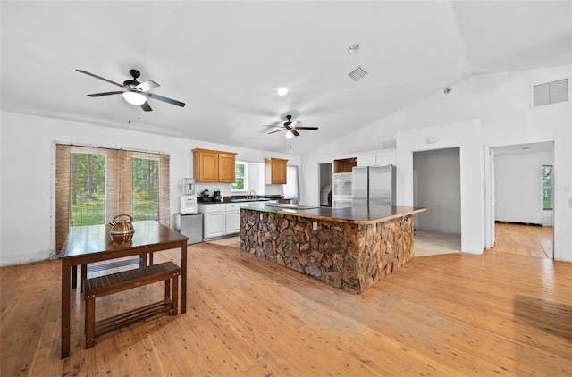 kitchen featuring light hardwood / wood-style floors, a kitchen island, and ceiling fan