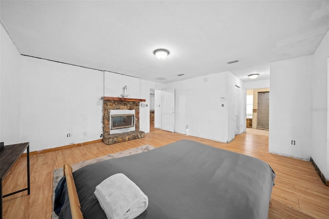 living room with light hardwood / wood-style flooring and a fireplace