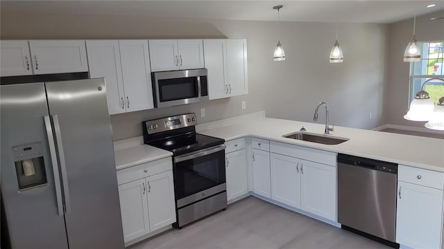 kitchen with sink, appliances with stainless steel finishes, and white cabinetry