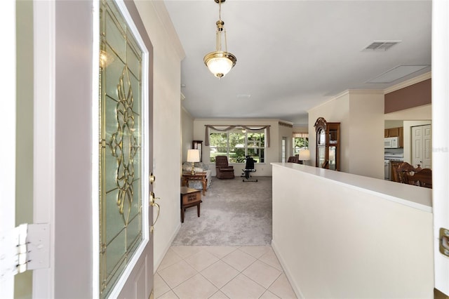 corridor featuring crown molding and light carpet