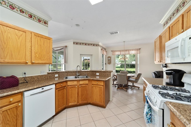 kitchen featuring sink, white appliances, kitchen peninsula, and a healthy amount of sunlight