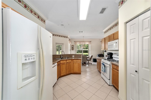 kitchen featuring pendant lighting, white appliances, sink, ornamental molding, and light tile patterned floors