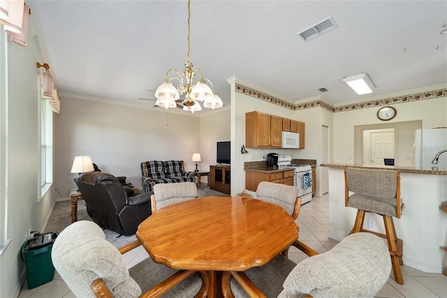 dining space with ceiling fan with notable chandelier, light tile patterned floors, and ornamental molding