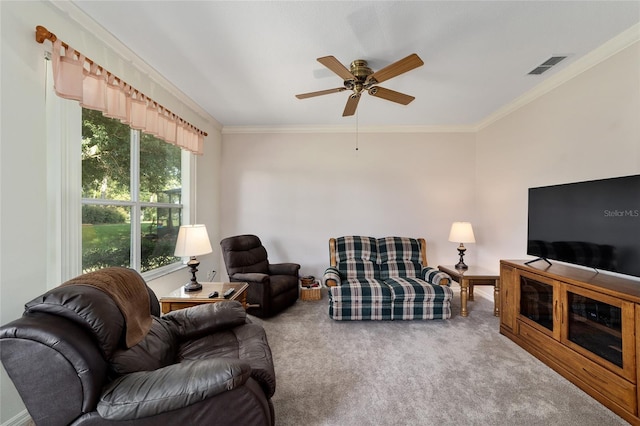 carpeted living room with ceiling fan and crown molding