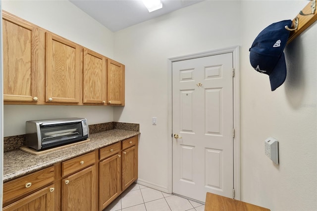 kitchen with light tile patterned flooring