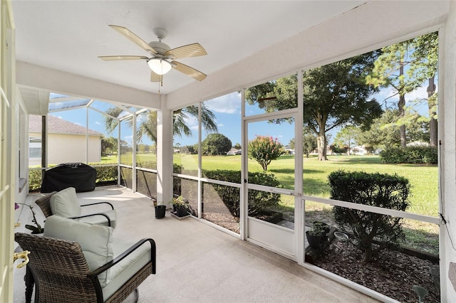 sunroom / solarium featuring ceiling fan and a healthy amount of sunlight