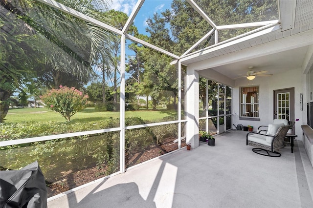 sunroom / solarium featuring ceiling fan