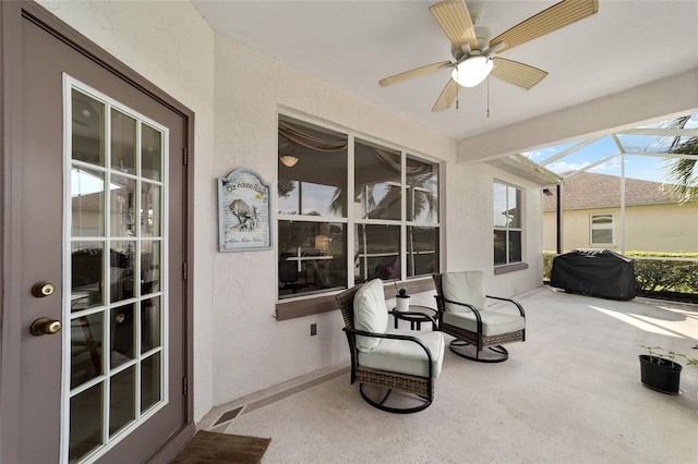 sunroom / solarium featuring ceiling fan