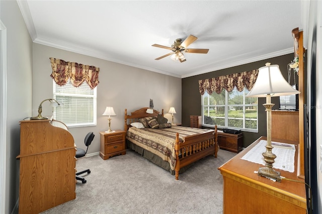 bedroom featuring ceiling fan, ornamental molding, and light colored carpet