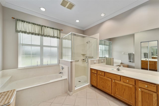 bathroom featuring a wealth of natural light, vanity, independent shower and bath, and tile patterned flooring