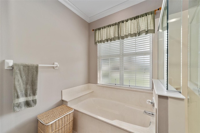 bathroom with a wealth of natural light, a tub to relax in, and ornamental molding