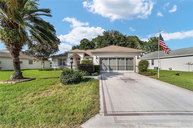 single story home featuring a garage and a front lawn