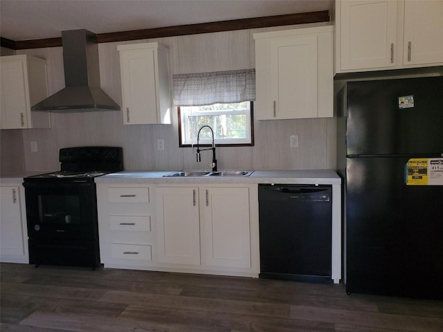 kitchen with wall chimney range hood, black appliances, sink, and white cabinets