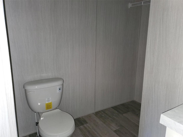 bathroom featuring wood-type flooring and toilet