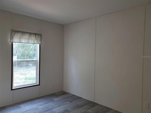 unfurnished room with wood-type flooring