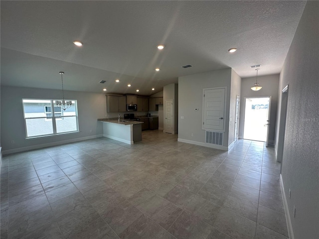 kitchen featuring baseboards, open floor plan, stainless steel appliances, and visible vents