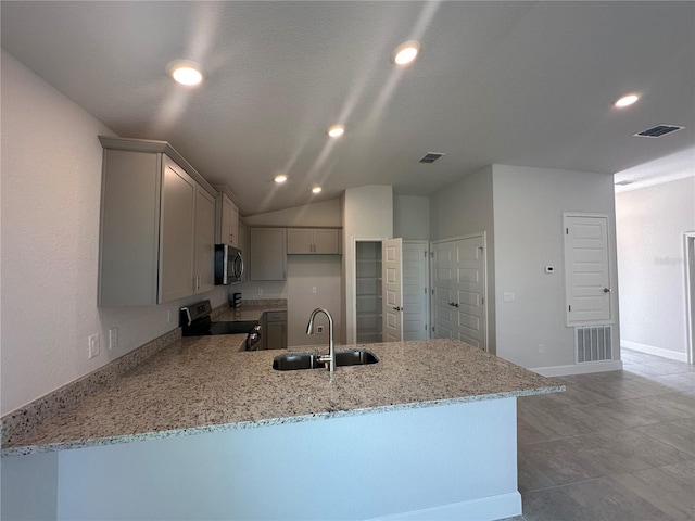 kitchen featuring visible vents, gray cabinetry, stainless steel appliances, and a sink