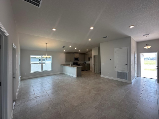 kitchen featuring stainless steel appliances, visible vents, open floor plan, and a chandelier