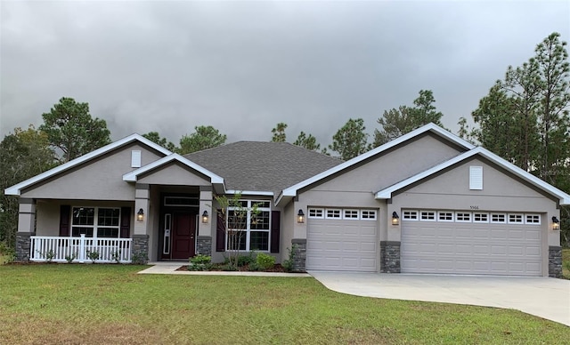 craftsman-style house featuring a garage, a front lawn, and a porch