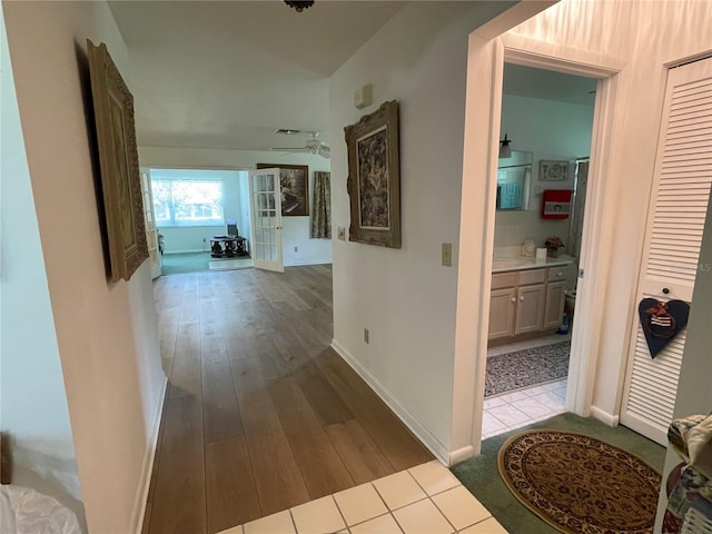 hall with light tile patterned floors