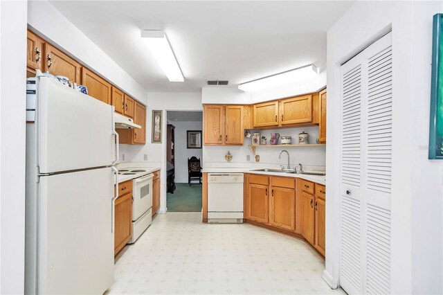 kitchen featuring sink, white appliances, and light tile patterned floors